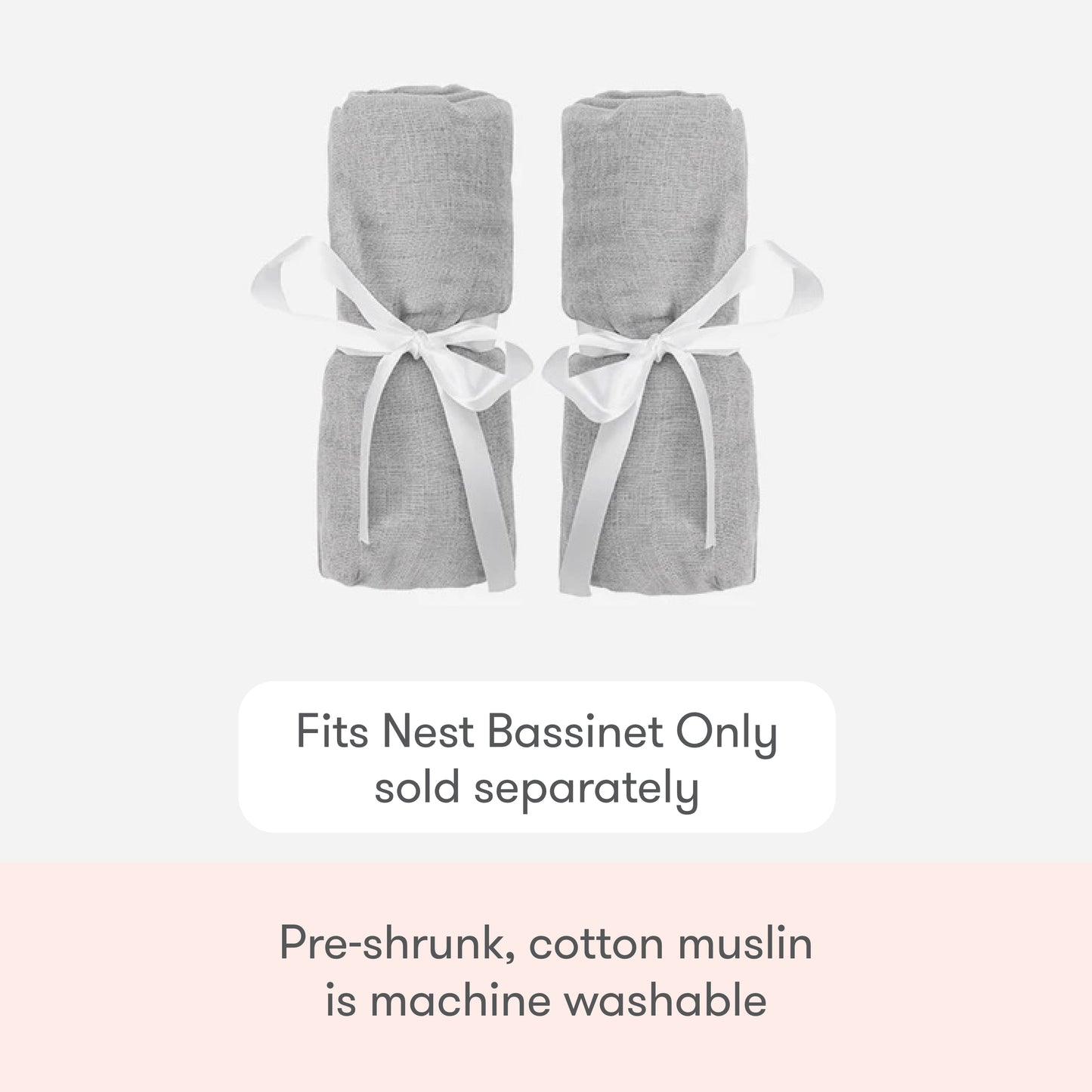 Two rolled-up light gray Newton Baby Nest Bassinet Extra Sheets are tied with white ribbons. These pre-shrunk, machine-washable cotton muslin crib sheets fit the Nest Bassinet (sold separately) and offer breathable comfort.