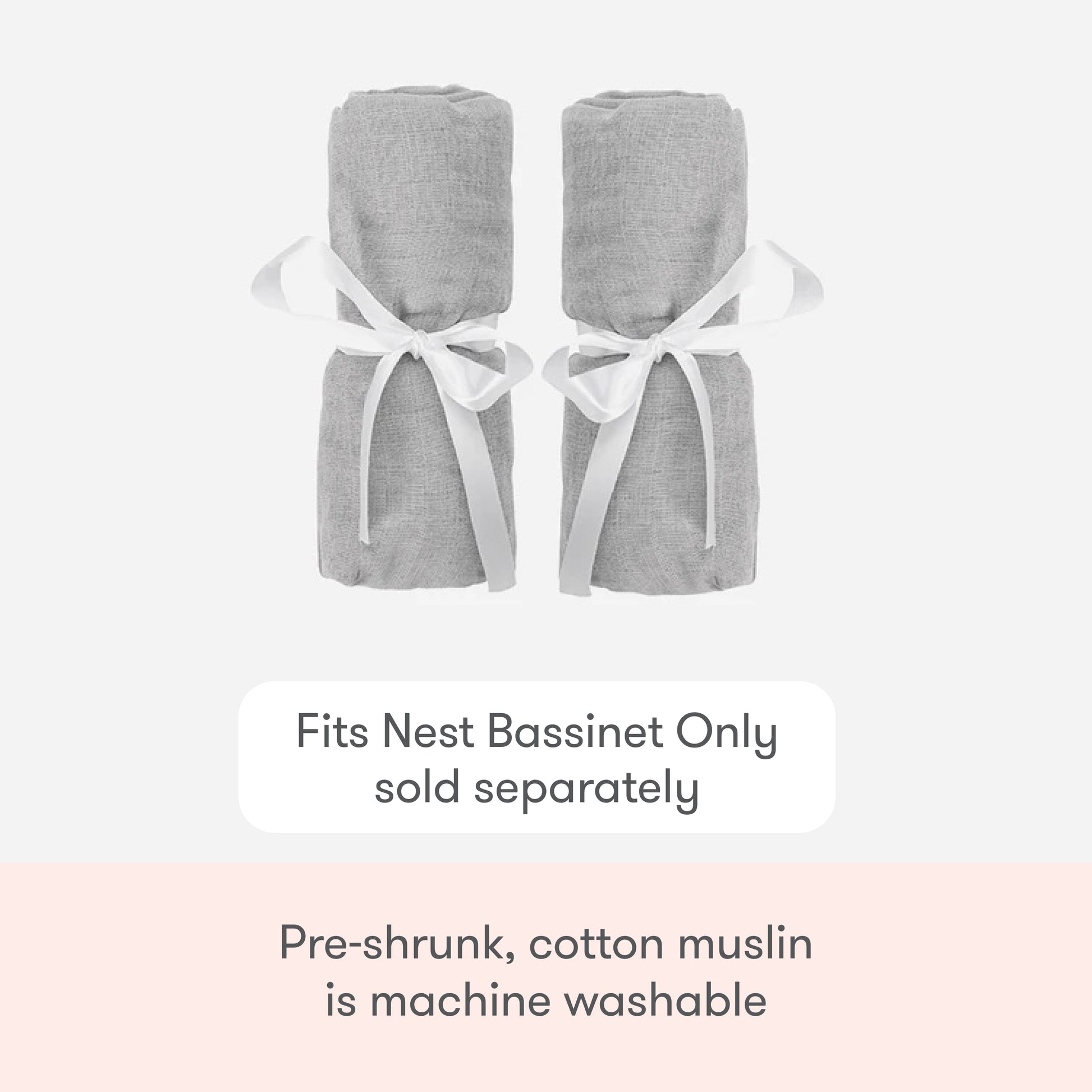 Two rolled-up light gray Newton Baby Nest Bassinet Extra Sheets are tied with white ribbons. These pre-shrunk, machine-washable cotton muslin crib sheets fit the Nest Bassinet (sold separately) and offer breathable comfort.