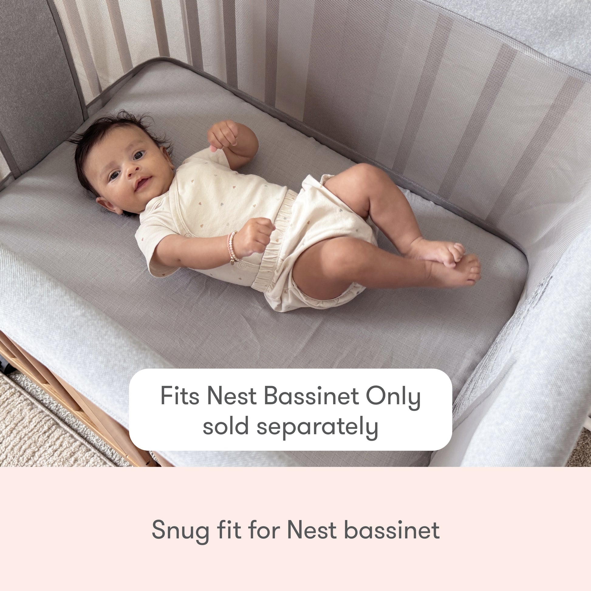 A baby lies in a light gray Nest Bassinet. Text reads, “Newton Baby Nest Bassinet Extra Sheets—fits snugly, compatible with cotton muslin and breathable crib sheets. For use with Nest Bassinet only (sold separately).”.