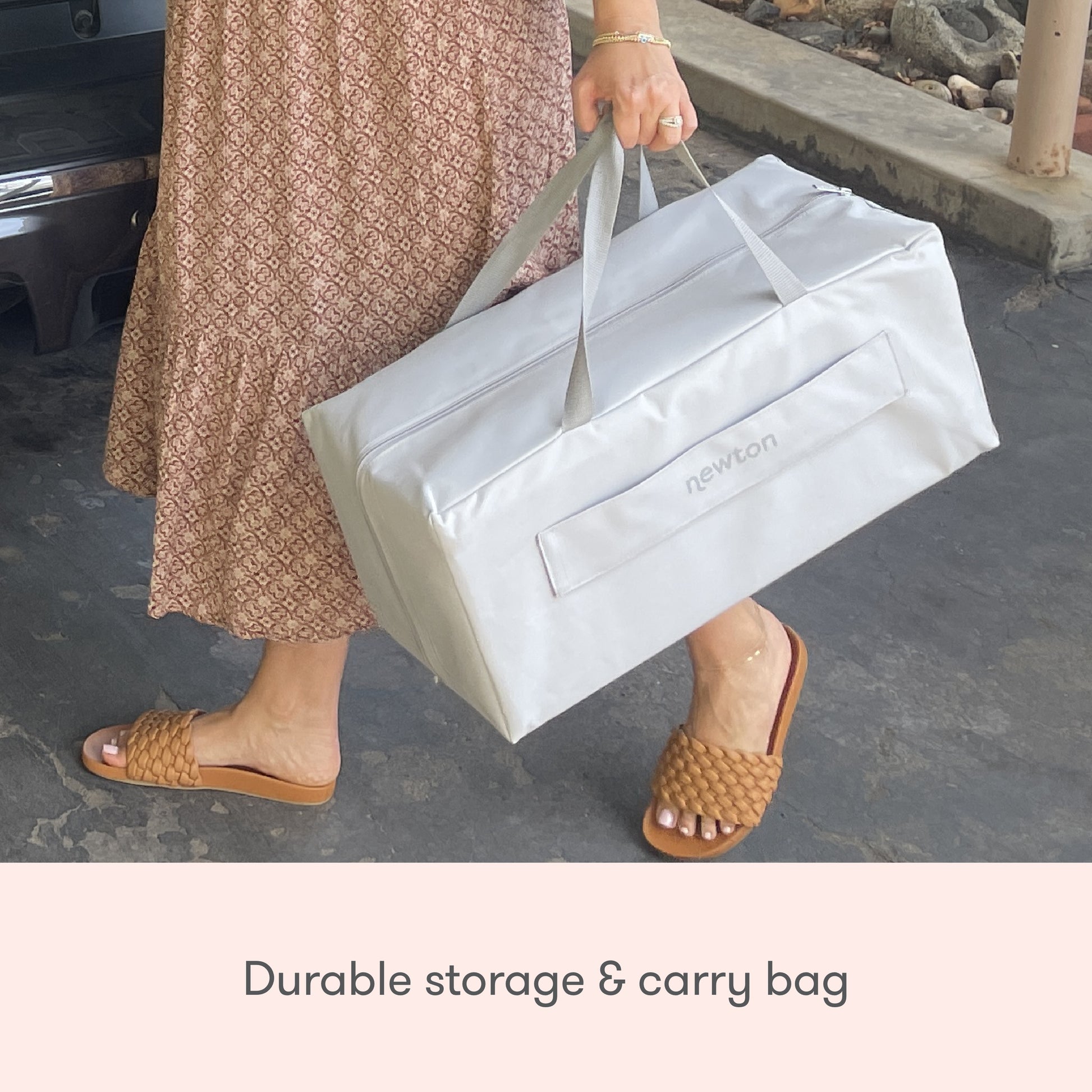 woman holding travel crib in carry bag, with text "durable storage & carry bad" Bassinet Only