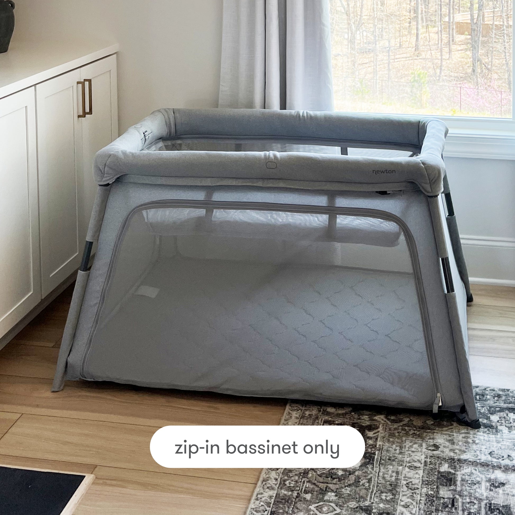 travel crib with bassinet insert in living room with text "zip-in bassinet only" Bassinet Only