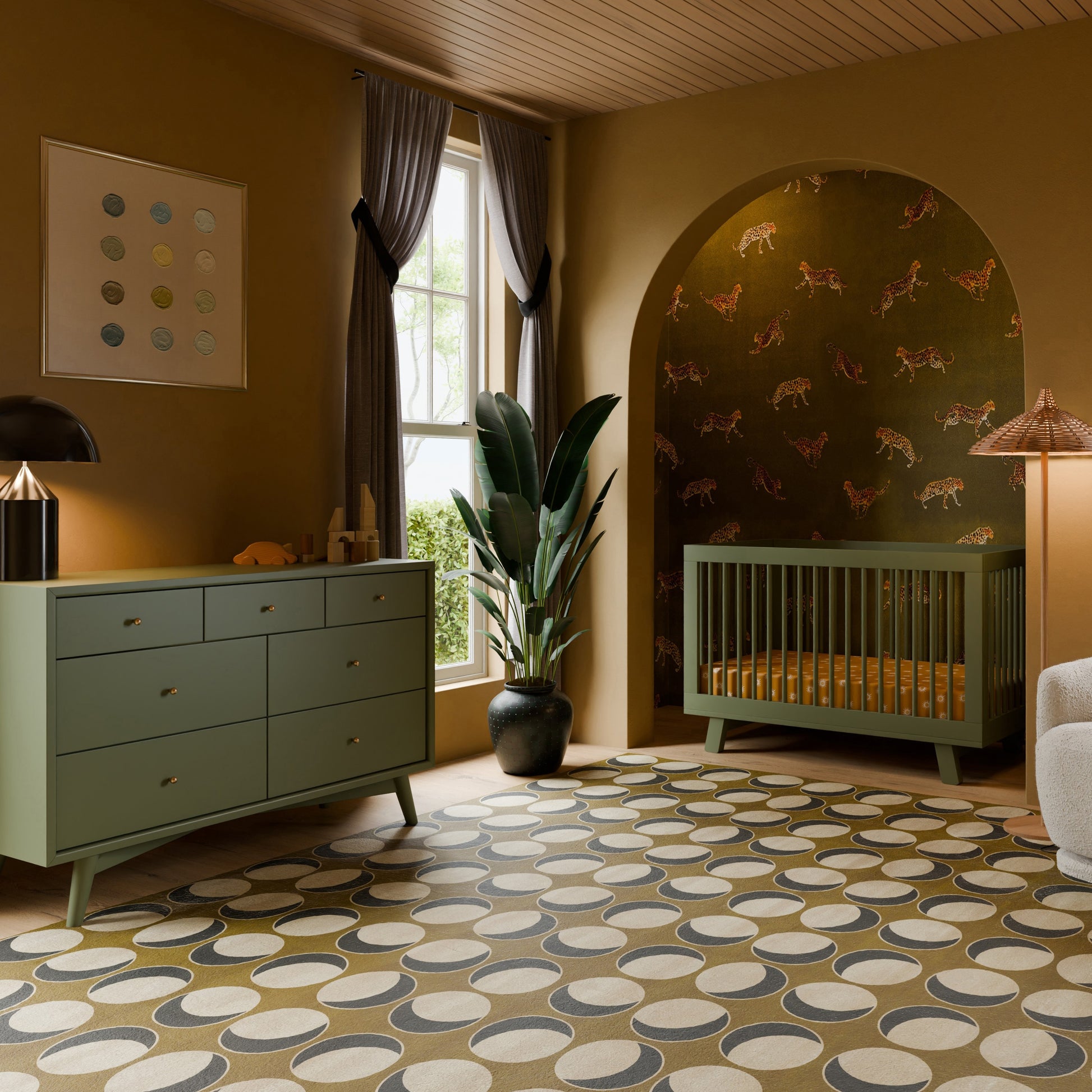 A stylish nursery featuring green furniture, a Babyletto Hudson Convertible Crib and dresser, a patterned rug, tall plant, window with gray curtains, and charming animal illustration wallpaper behind the crib.