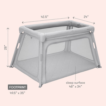 The Newton Baby Deluxe Travel Crib & Play Yard is shown on a light pink background. It features gray mesh sides, a breathable crib mattress (48" x 34" sleep surface), and measures 42.5" L x 24" W x 28" H with a 49.5" x 35" footprint.