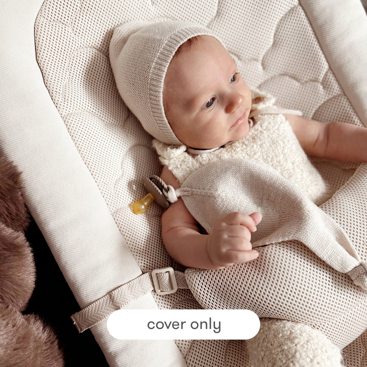 A baby dressed in a cream-colored knit outfit lies comfortably in a Newton Baby Rocker outfitted with the Extra Cover, featuring a breathable seat cover and mesh accents. The text “cover only” appears at the bottom of the image.