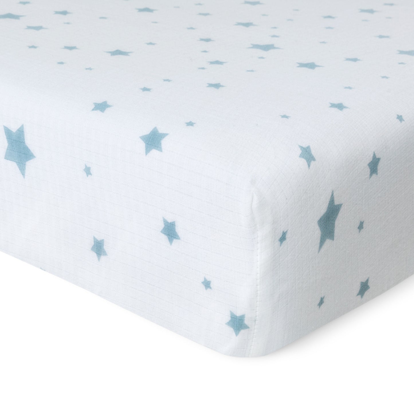 Close-up of Newton Baby’s Breathable, Organic Cotton Sheets (2-pack), showing a white muslin sheet with light blue stars in various sizes, snugly fitted on the mattress and set against a plain white background.