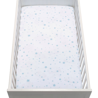 A top-view image shows a white baby crib with Newton Baby Breathable, Organic Cotton Sheets (2-pack) and white bedding featuring light blue stars of various sizes, highlighting the mattress and crib rails.