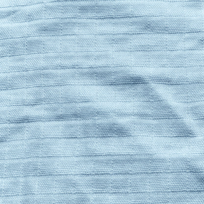 Close-up of light blue textured fabric with subtle horizontal stripes and soft wrinkles, featured in Newton Baby's Breathable, Organic Cotton Sheets (2-pack)—perfect for crib bedding.