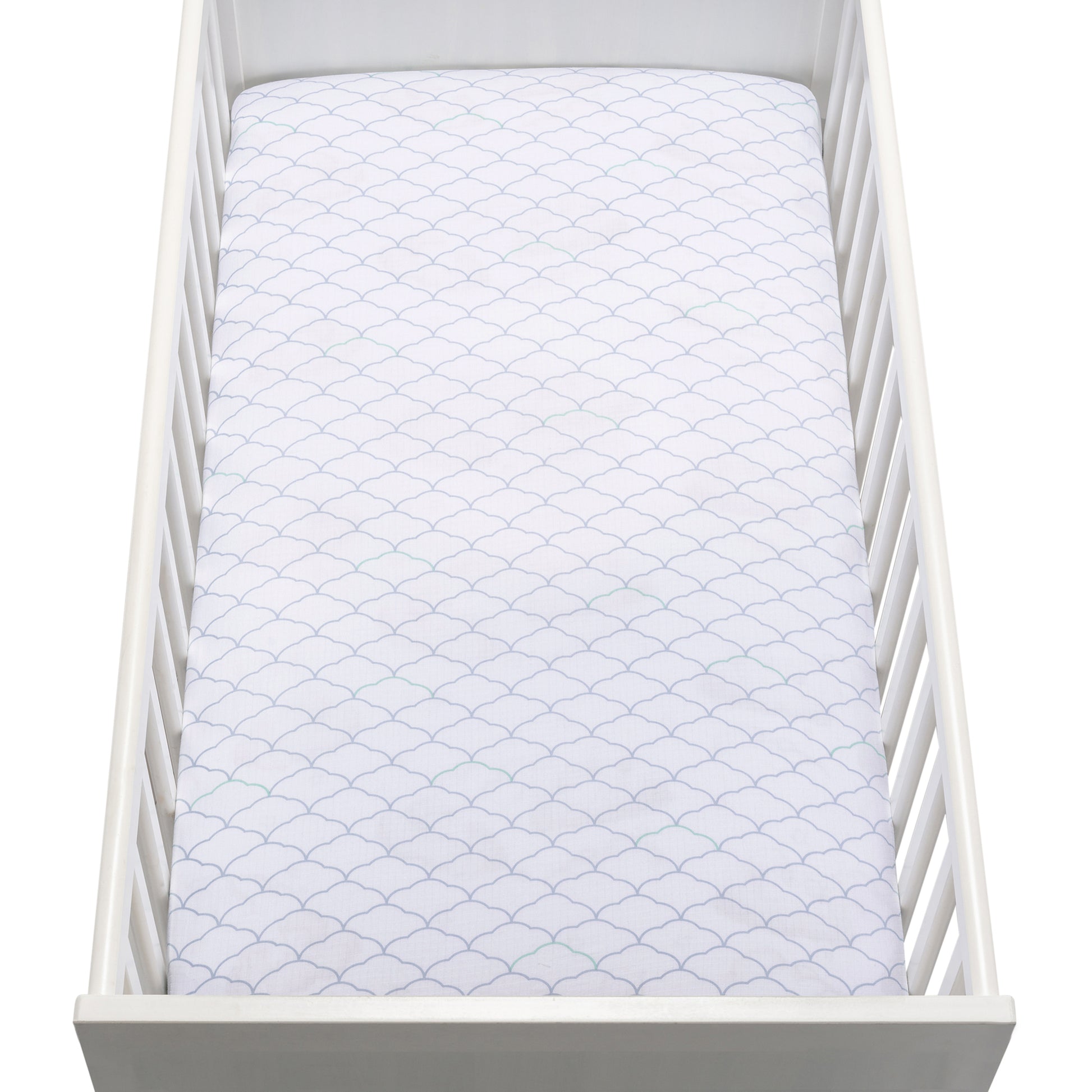 A white crib holds a mattress covered with a Newton Baby Breathable, Organic Cotton Sheet (2-pack) in white, featuring a subtle scalloped pattern. The photo is taken from above.