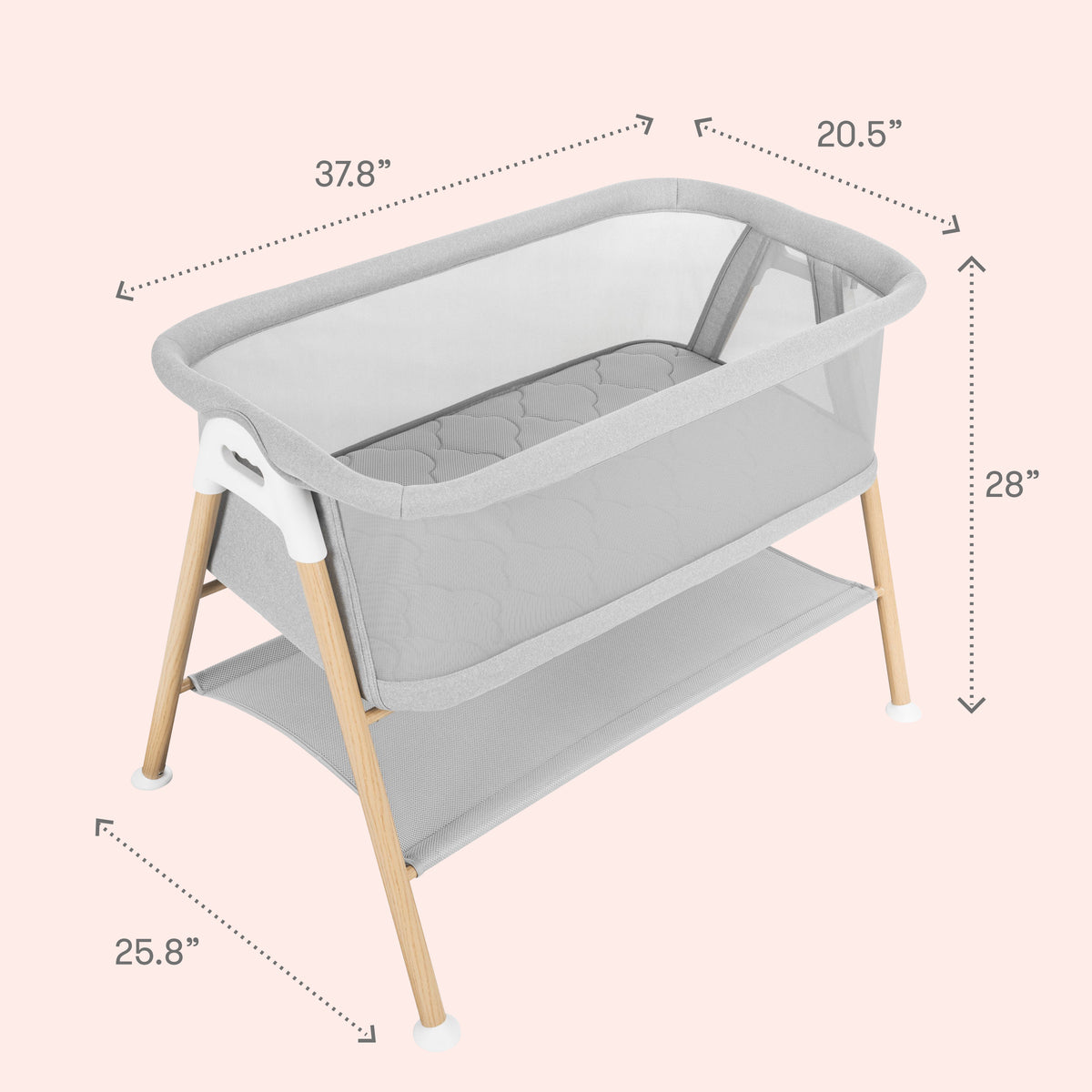 The Newton Baby Essential Bassinet features a sleek gray design with wooden legs and breathable mesh sides. Shown against a pale pink background that accentuates its modern style, the bassinet has labeled dimensions of 37.8″ long, 20.5″ wide, 28″ high, and a base depth of 25.8″. A convenient storage shelf sits beneath the sleeping area, while the included breathe-thru mattress from Newton Baby provides comfort and safety for your little one.