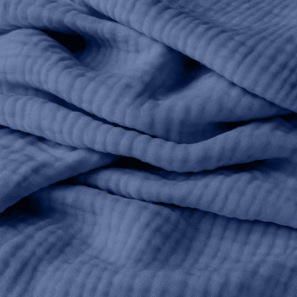 Close-up of breathable, organic cotton fabric from Newton Baby's 2-pack sheets, featuring gentle folds and textured ridges—perfect for adding comfort and depth to your little one's crib.