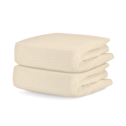 Two neatly folded Newton Baby Breathable, Organic Cotton Sheets (2-pack) stacked on top of each other against a white background.