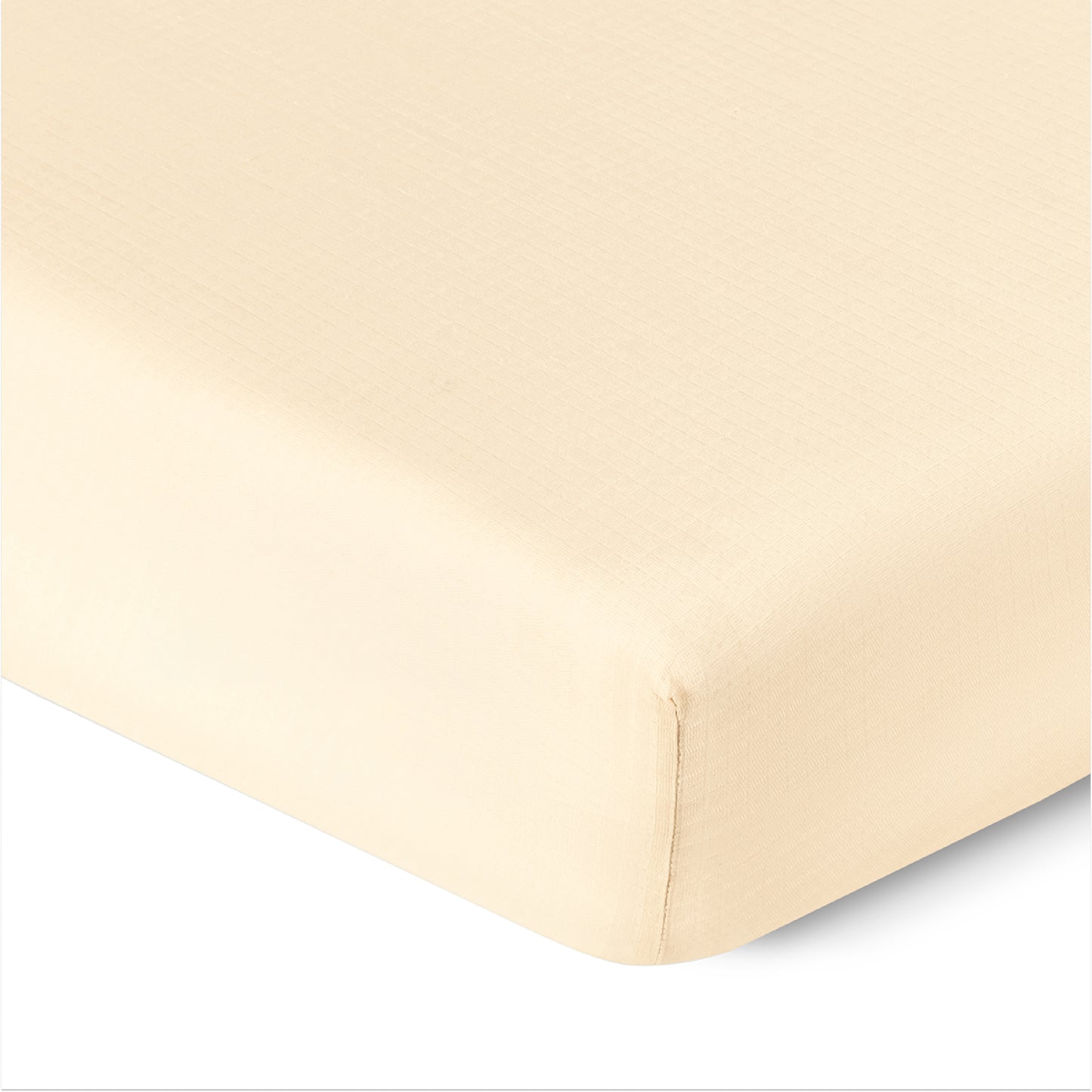Close-up of a corner of Newton Baby Breathable, Organic Cotton Sheets (2-pack) on a mattress, showing the smooth, tightly-fitted fabric and clean edges.