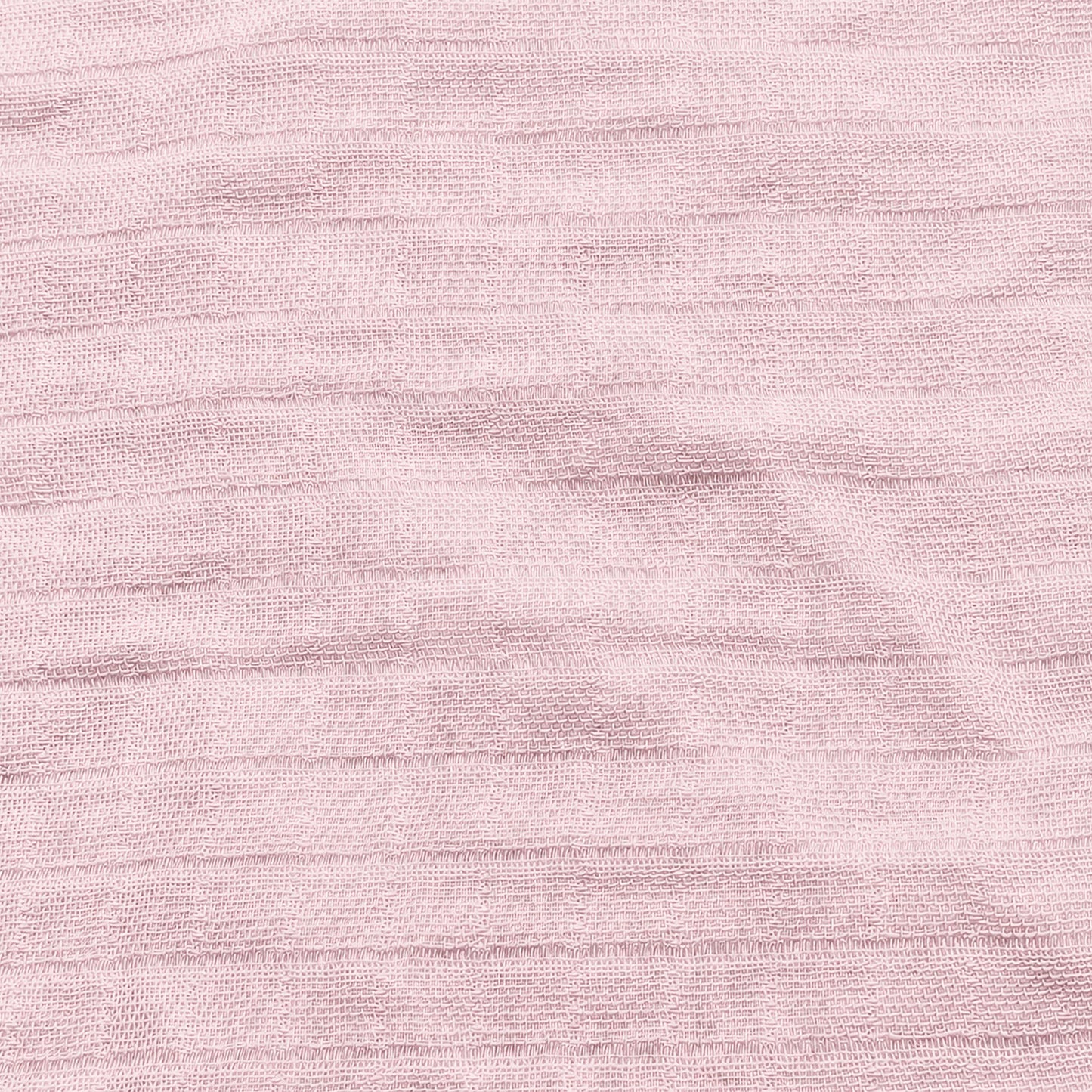 Close-up of Newton Baby Breathable, Organic Cotton Sheets (2-pack) in light pink, showing textured fabric with subtle horizontal lines and a gently wrinkled finish.