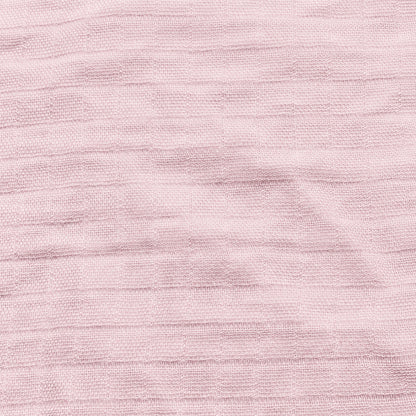 Close-up of Newton Baby Breathable, Organic Cotton Sheets (2-pack) in light pink, showing textured fabric with subtle horizontal lines and a gently wrinkled finish.