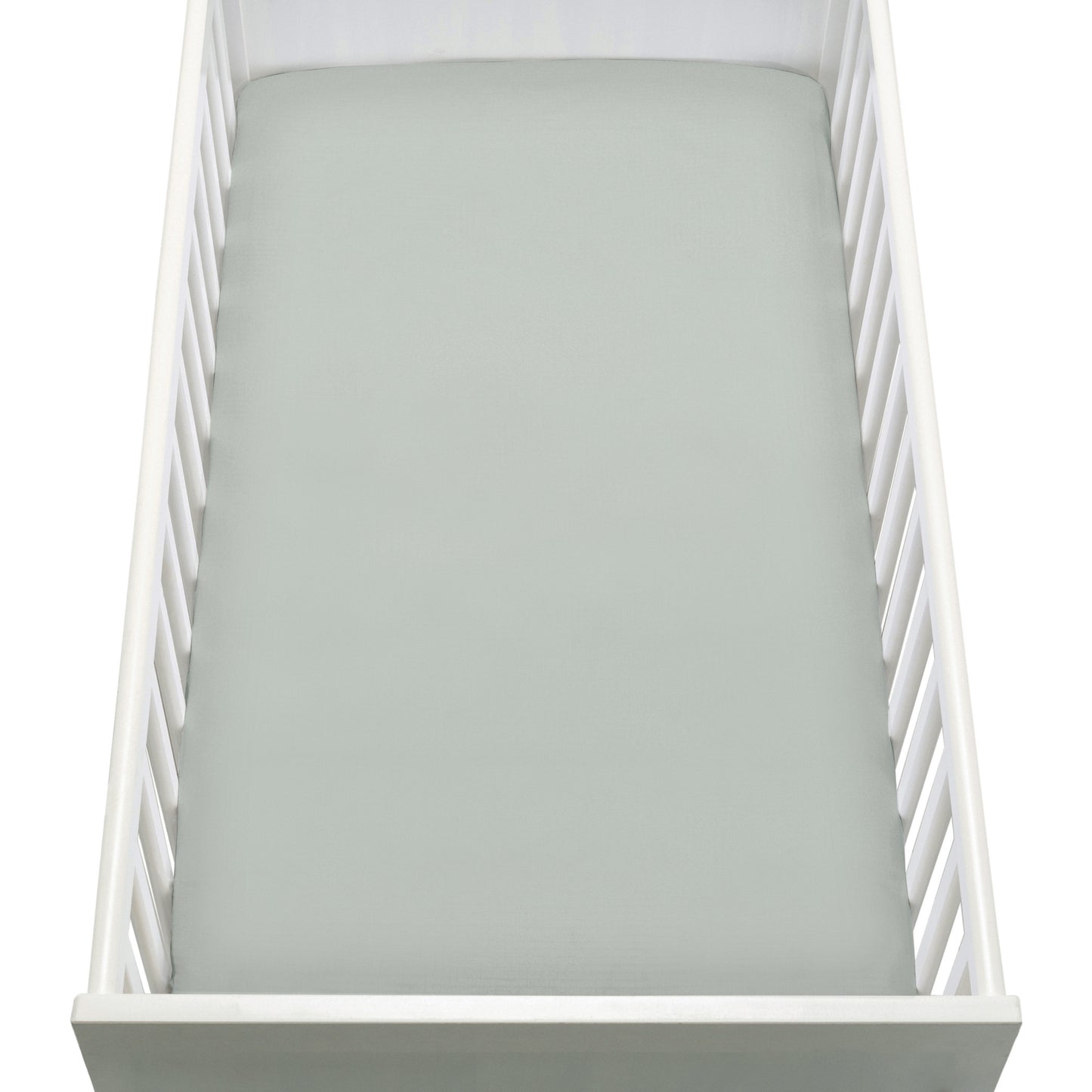 A top-down view of a white baby crib with a Newton Baby Breathable, Organic Cotton Sheet (2-pack) in light gray on the mattress. The crib has slatted sides and a solid end panel.