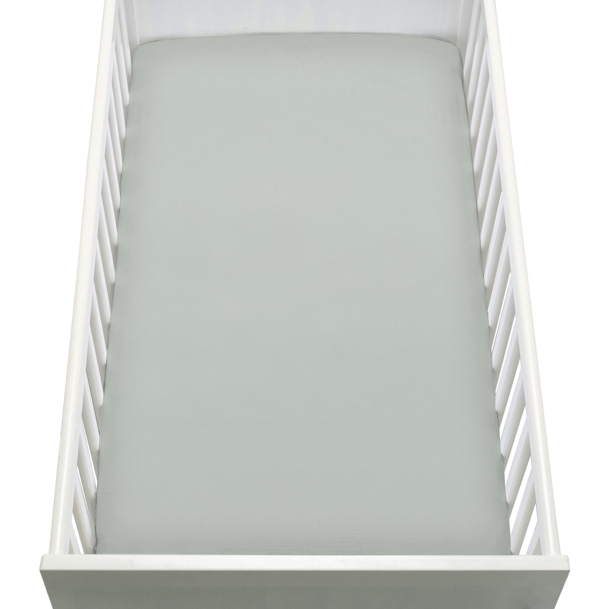 A top-down view of a white baby crib with a Newton Baby Breathable, Organic Cotton Sheet (2-pack) in light gray on the mattress. The crib has slatted sides and a solid end panel.
