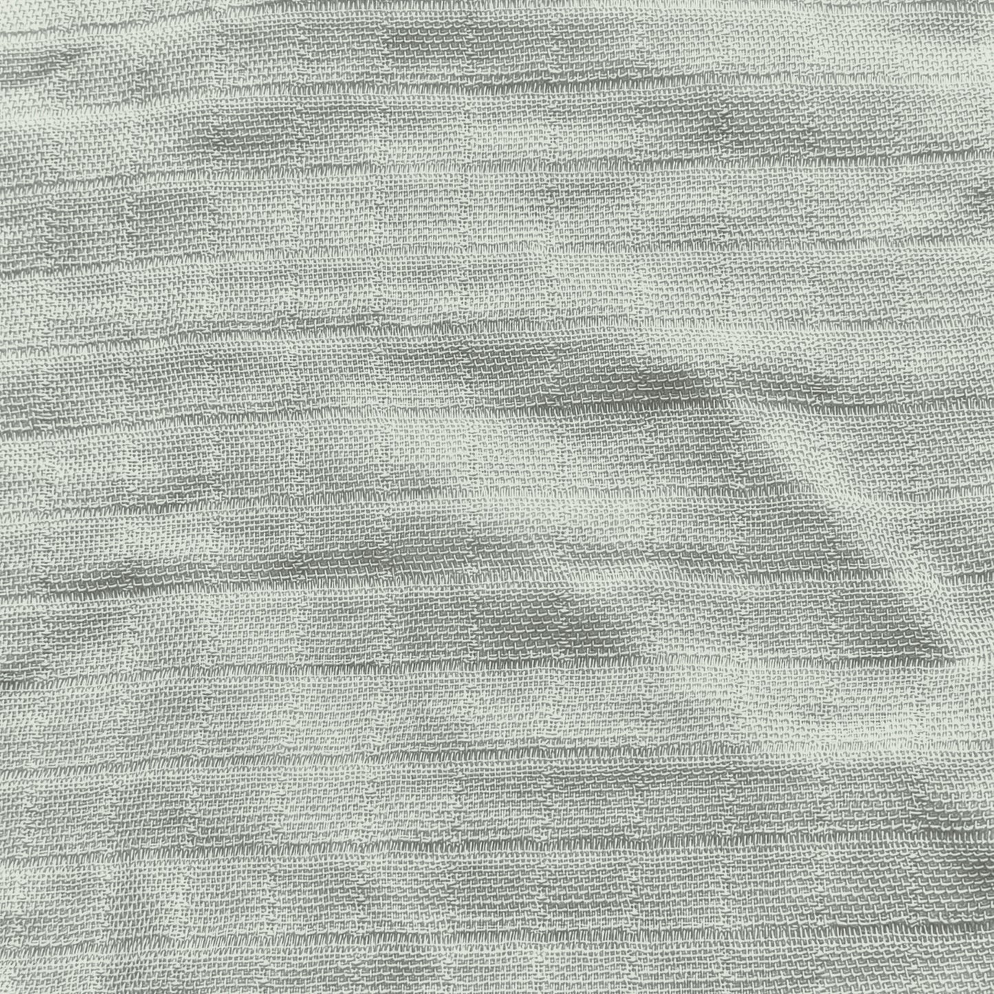 Newton Baby’s Breathable, Organic Cotton Sheets (2-pack) feature a light gray color, subtle horizontal ridges, and a slightly uneven texture for a soft, minimalist look with natural variations in the weave.