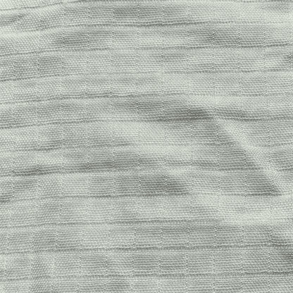 Newton Baby’s Breathable, Organic Cotton Sheets (2-pack) feature a light gray color, subtle horizontal ridges, and a slightly uneven texture for a soft, minimalist look with natural variations in the weave.