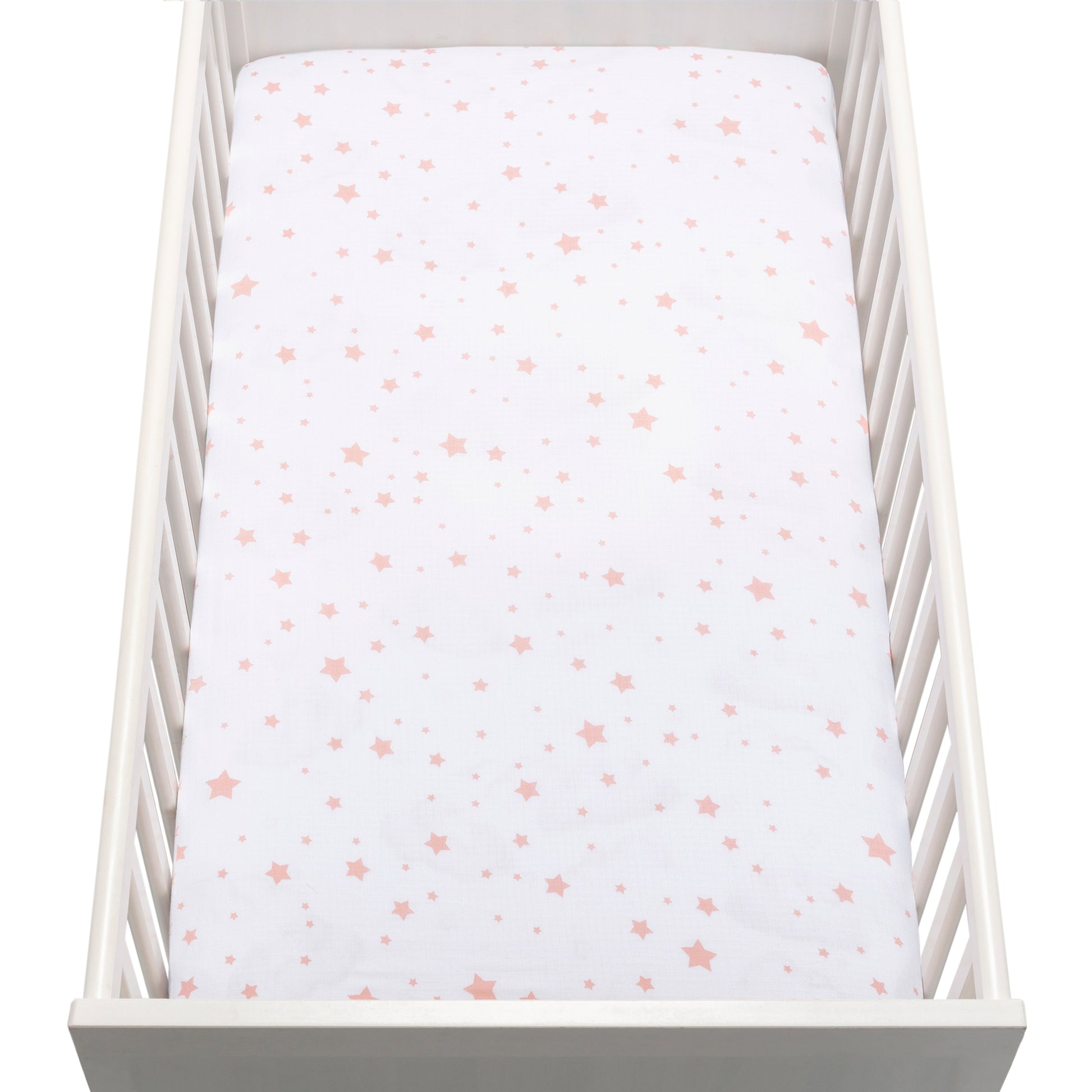 A white baby crib with a mattress covered in Newton Baby’s breathable, organic cotton sheet featuring pink and peach stars.
