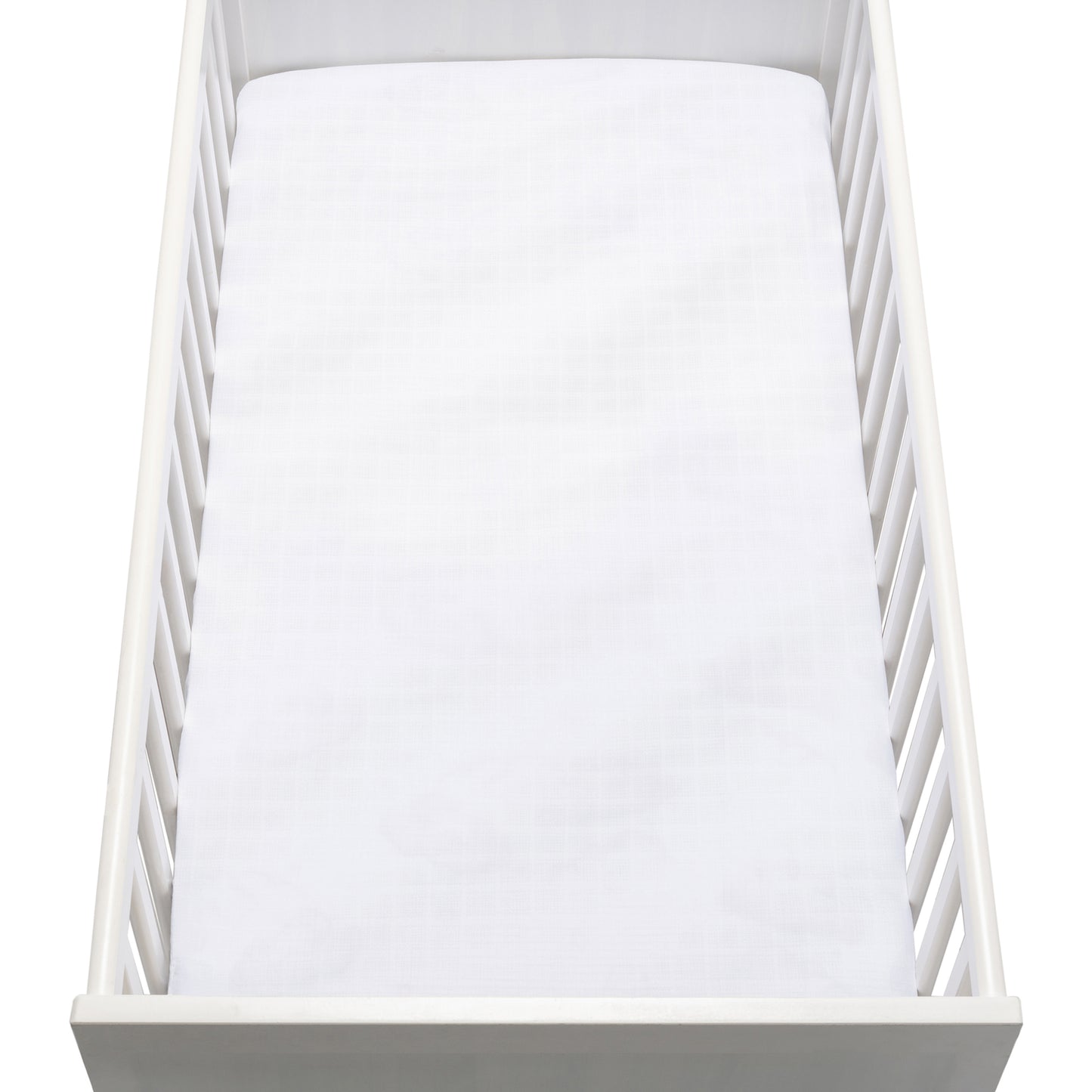 A white crib with vertical slats and a plain mattress is topped with Newton Baby’s Breathable, Organic Cotton Sheets (2-pack), as seen from above.