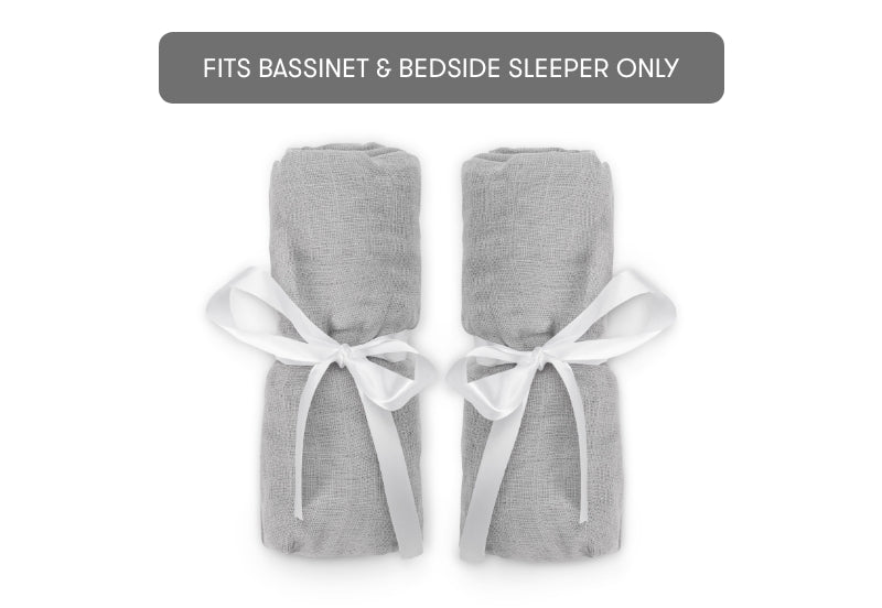 Two gray swaddle blankets tied with white ribbon and labeled "FITS BASSINET & BEDSIDE SLEEPER ONLY."