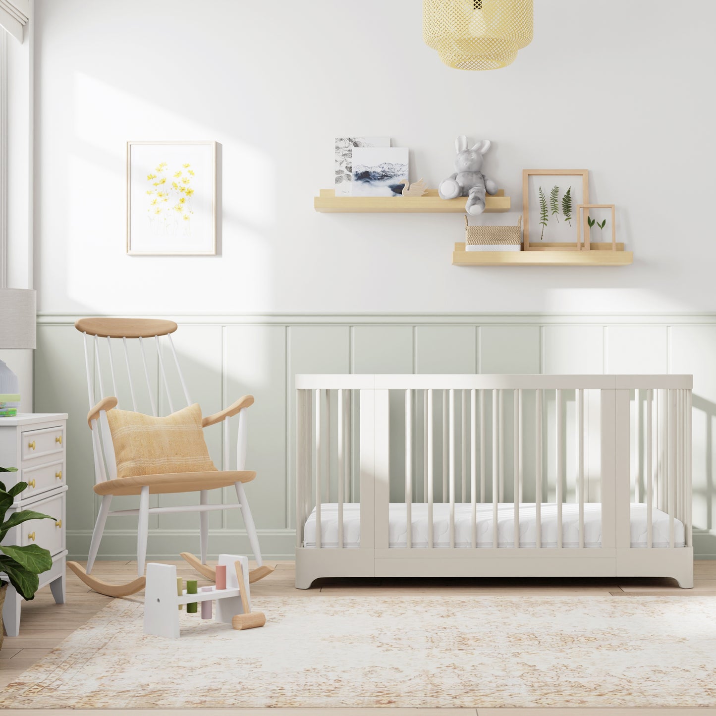 Chestnut color Newton Nest Convertible Crib in crib setting, in nursery next to rocking chair
