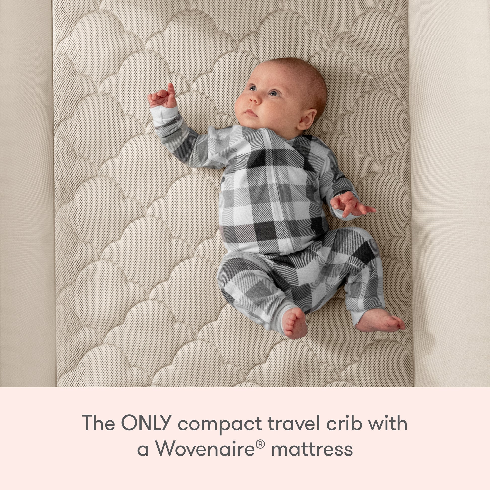 A baby in a black, white, and gray plaid outfit lies on a textured crib mattress. Text below reads: Newton Baby Compact Travel Crib & Play Yard—the only compact travel crib with a breathable Wovenaire® mattress.