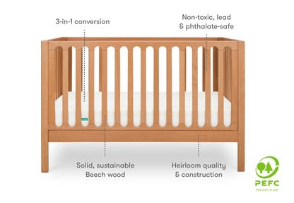 A wooden baby crib featuring 3-in-1 conversion, non-toxic and safe materials, made from solid, sustainable beech wood, with a PEFC certification logo on the right side.
