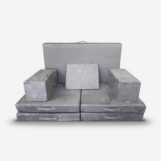The Figgy Newton X Figgy Play Couch by Figgy is a modular gray sofa crafted with CertiPUR-US certified foam. It includes two rectangular armrests, a backrest, and seat cushions, all in soft fabric and displayed on a white background.