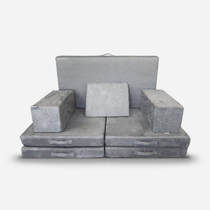 The Figgy Newton X Figgy Play Couch by Figgy is a modular gray sofa crafted with CertiPUR-US certified foam. It includes two rectangular armrests, a backrest, and seat cushions, all in soft fabric and displayed on a white background.