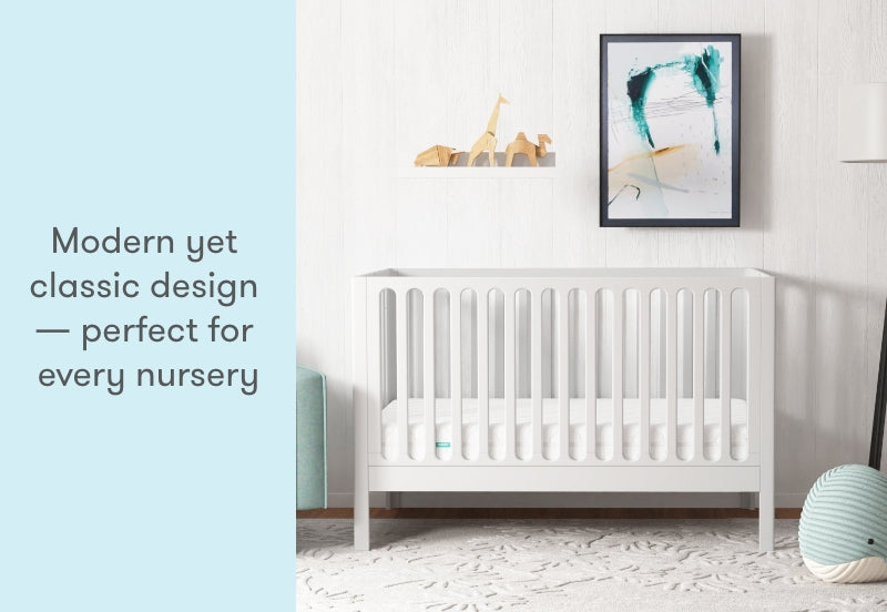 A modern yet classic white crib in a stylish nursery, with text stating "Modern yet classic design — perfect for every nursery."