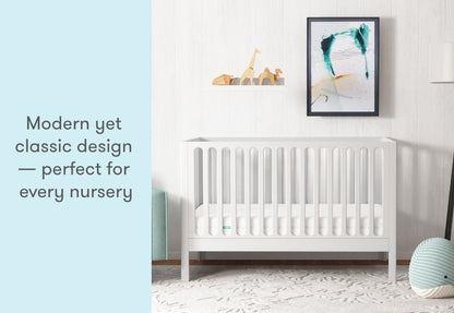 A modern yet classic white crib in a stylish nursery, with text stating "Modern yet classic design — perfect for every nursery."