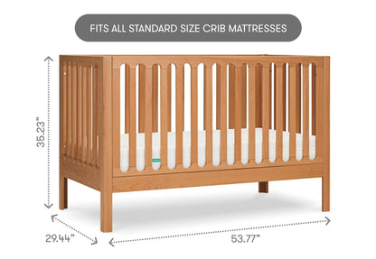 Wooden crib with dimensions labeled, stating "Fits all standard size crib mattresses."
