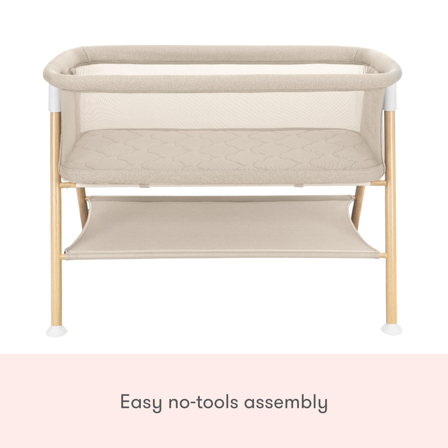The Newton Baby Essential Bassinet features a beige, non-toxic design with wooden legs, mesh sides, a lower storage shelf, and easy no-tools assembly.