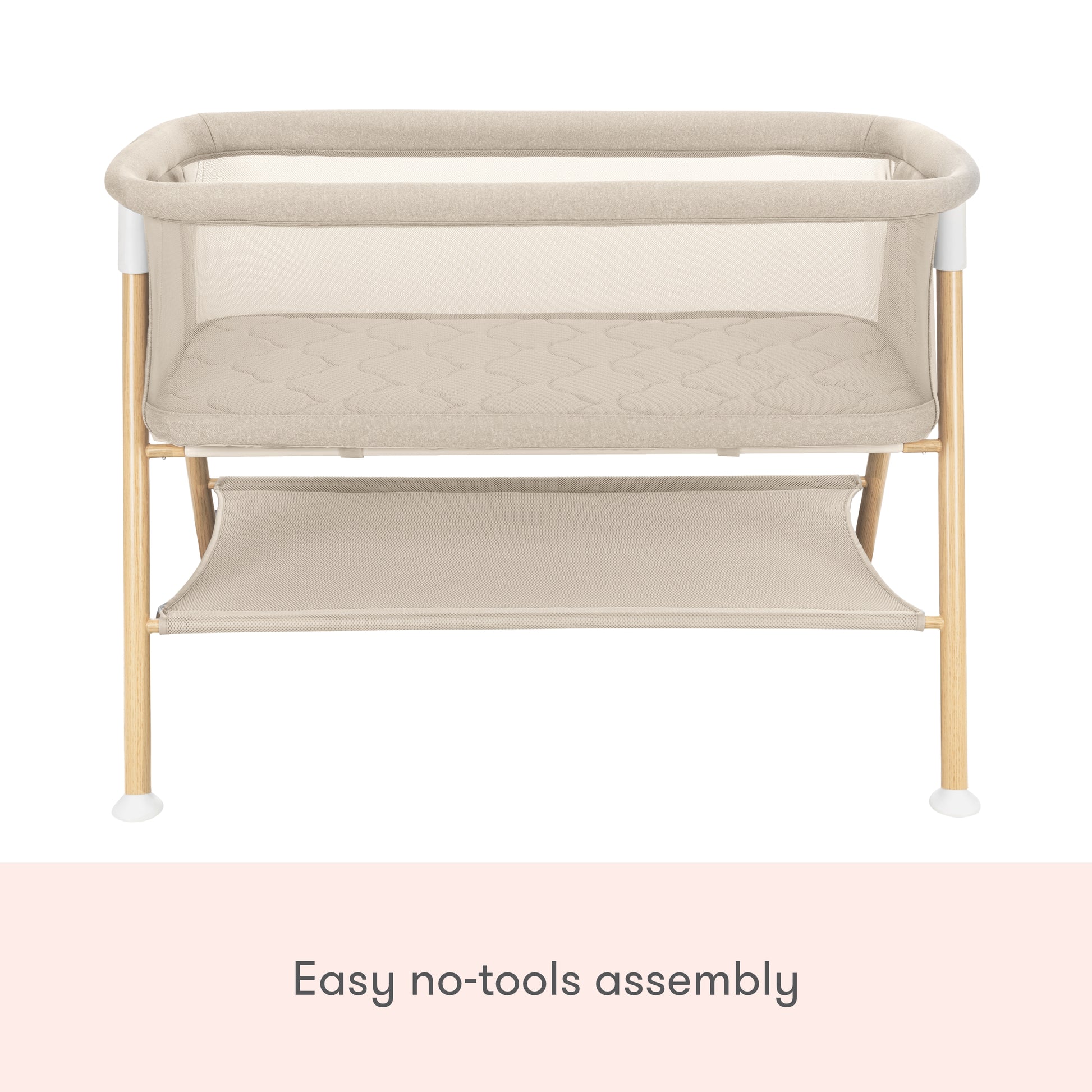 The Newton Baby Essential Bassinet features a beige, non-toxic design with wooden legs, mesh sides, a lower storage shelf, and easy no-tools assembly.