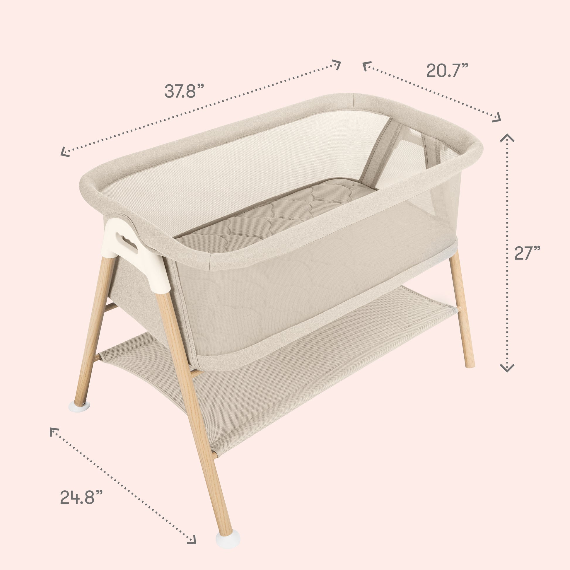 The Newton Baby Essential Bassinet features breathable mesh sides, wooden legs, a quilted breathe-thru mattress, and a lower storage shelf. Dimensions: 37.8"L x 20.7"W x 27"H; base depth 24.8". Shown on a pale pink background.