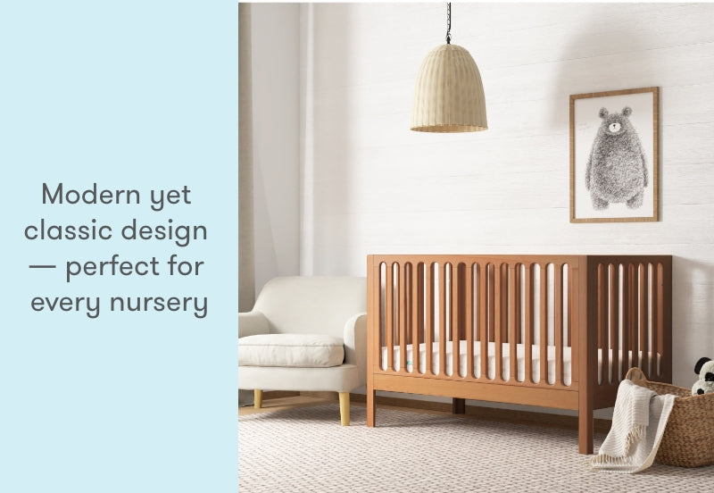 Modern yet classic designed nursery with a wooden crib, a framed rabbit illustration on the wall, and the text "Modern yet classic design — perfect for every nursery."
