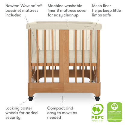 The Newton Nest Convertible Crib by Newton Baby is shown with washable mattress, breathable mesh liner for safety, locking caster wheels, compact mobile design, GREENGUARD Gold and PEFC certified materials.