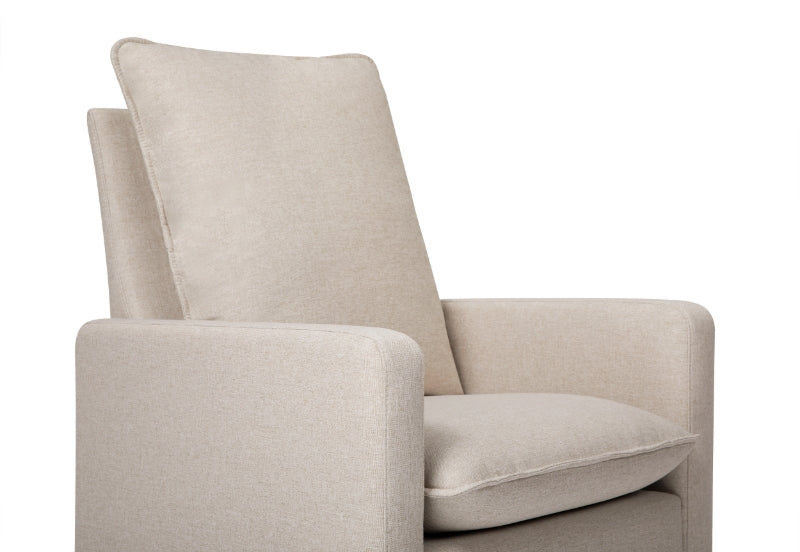 Beige upholstered nursery chair with a high back and cushioned armrests.