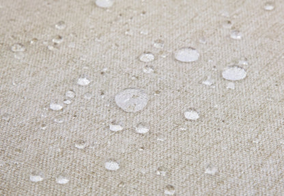 Water droplets on a textured fabric surface, demonstrating water resistance.