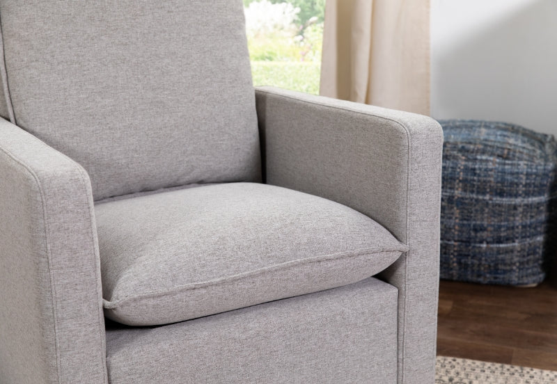 Close-up of a cozy gray armchair in a well-lit room, hinting at comfort and modern elegance.
