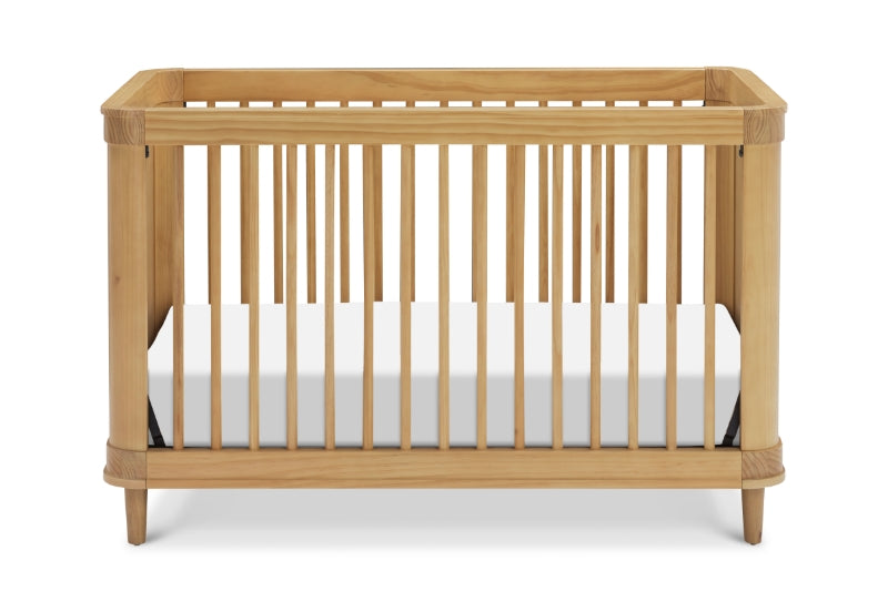 Natural wood baby crib with white mattress on a plain background.