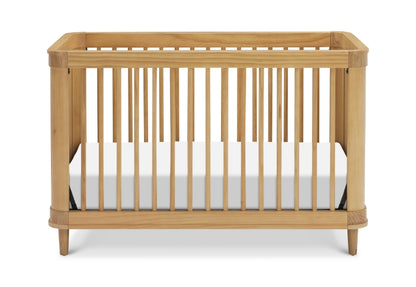 Natural wood baby crib with white mattress on a plain background.