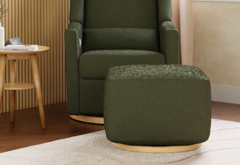 Green upholstered rocking chair with matching ottoman in a soothing nursery setting.