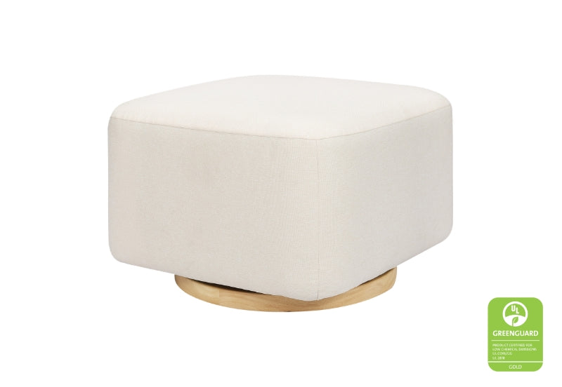 A modern, round white ottoman on a wooden base with a green "Greenguard" certification badge visible in the corner.