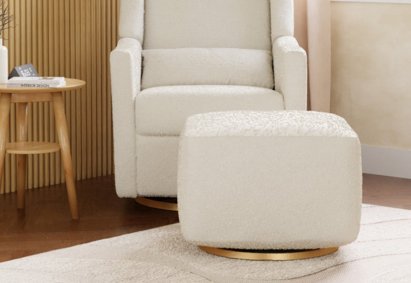Cozy nursery with a plush rocking chair and matching ottoman on a soft rug in a warmly decorated room.