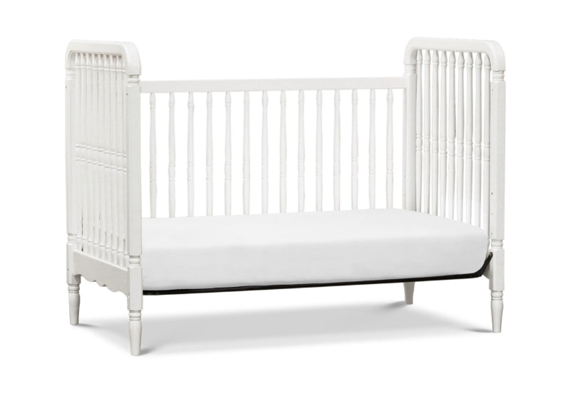 White vintage-style baby crib with vertical slats and decorative side rails on a white background.