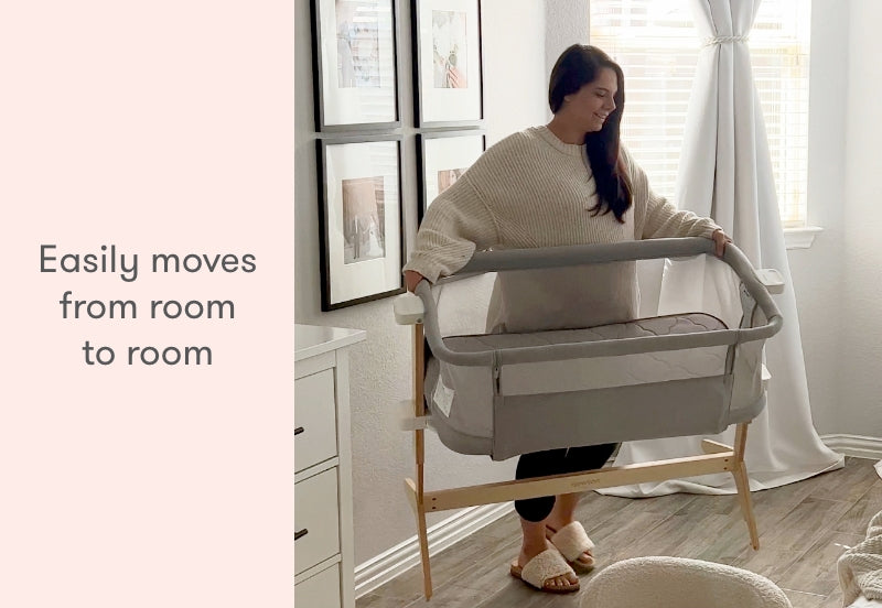 A woman smiling while demonstrating a portable baby bassinet with the caption "Easily moves from room to room."