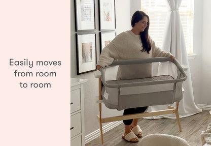 A woman smiling while demonstrating a portable baby bassinet with the caption "Easily moves from room to room."