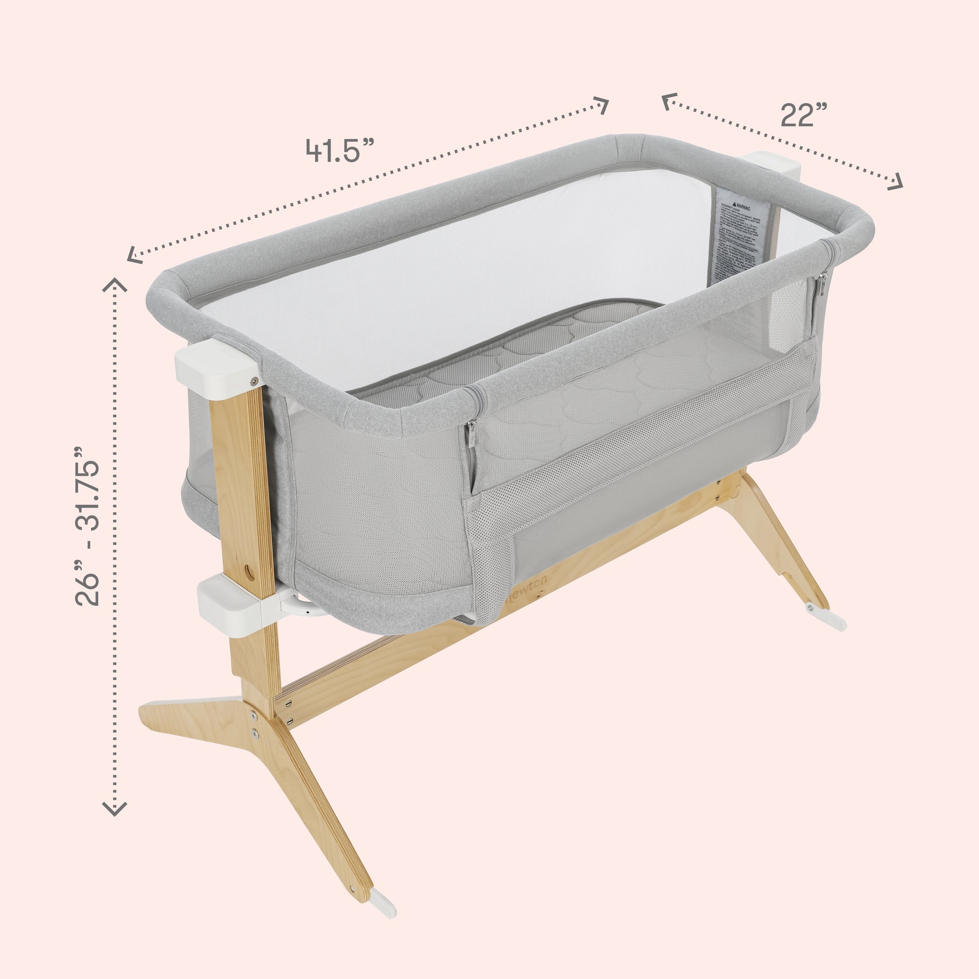 The Newton Baby Bundle 3 BFCM bassinet features a gray and white design with breathable mesh sides, wooden legs, and adjustable height from 26 to 31.75 inches. Dimensions: 41.5” L x 22” W.
